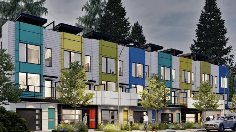 Modern row of townhomes with vibrant teal, lime green, and blue vertical panels. White siding and surrounding trees.