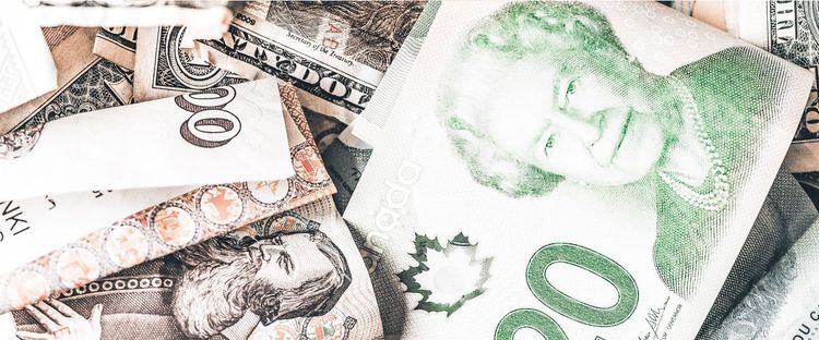 Various banknotes, including Canadian dollars with Queen Elizabeth II, US dollars, and other international currencies