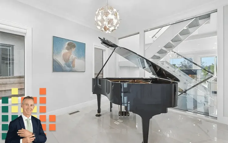 Man in suit over a modern living room with a grand piano, glass staircase, and chandelier.