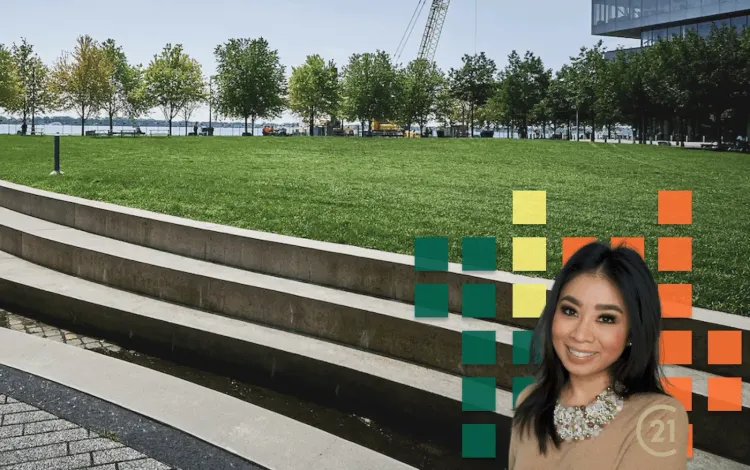 Smiling woman (Century 21) in a park with grass, trees, steps, water, and colorful graphic squares.